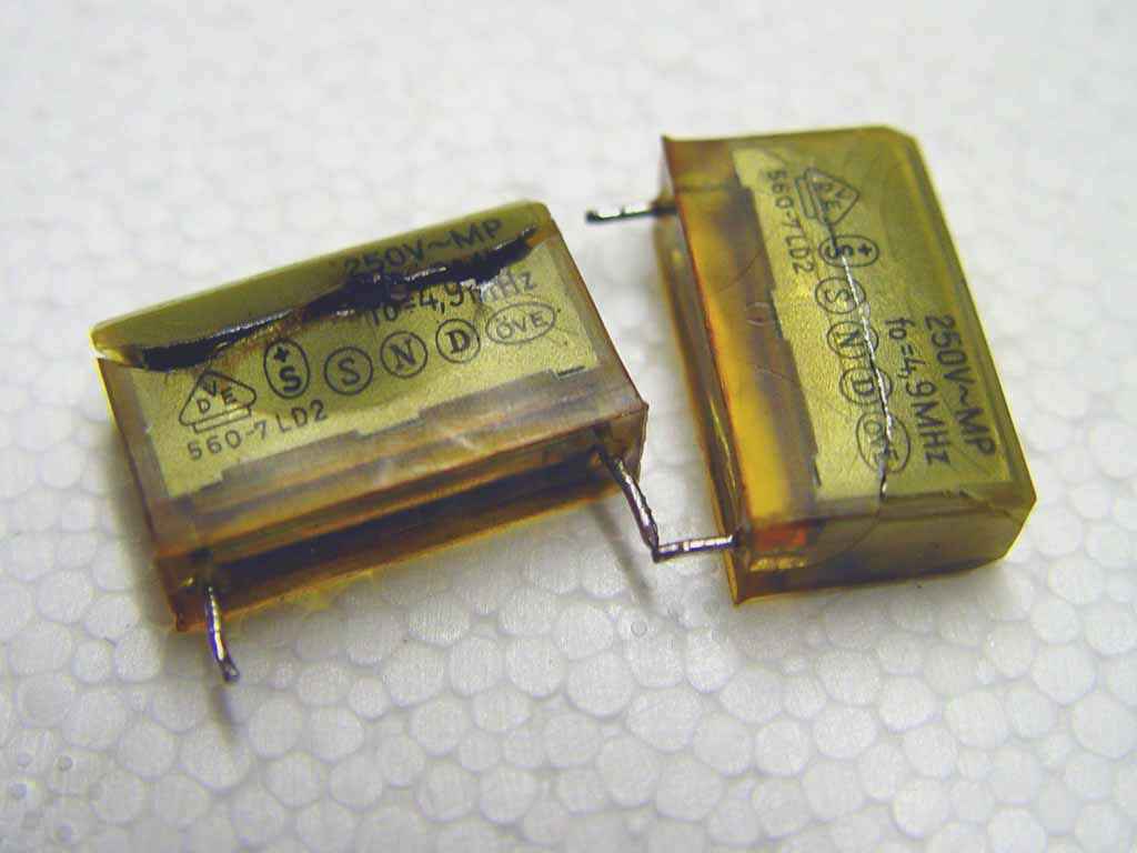 Two dead capacitors.
One short circuit,
one 'volcano' style.